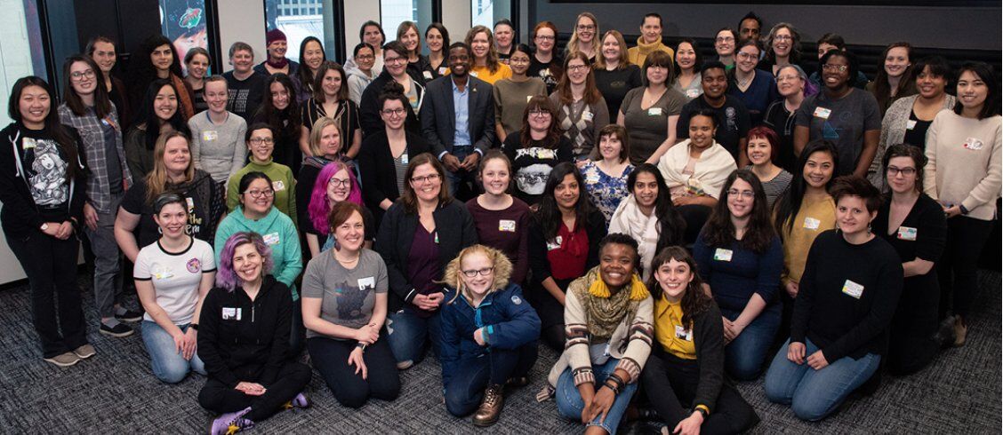 Photo of participants, mentors, and sponsors of the non-binary and women-oriented hackathon known as Hack the Gap
